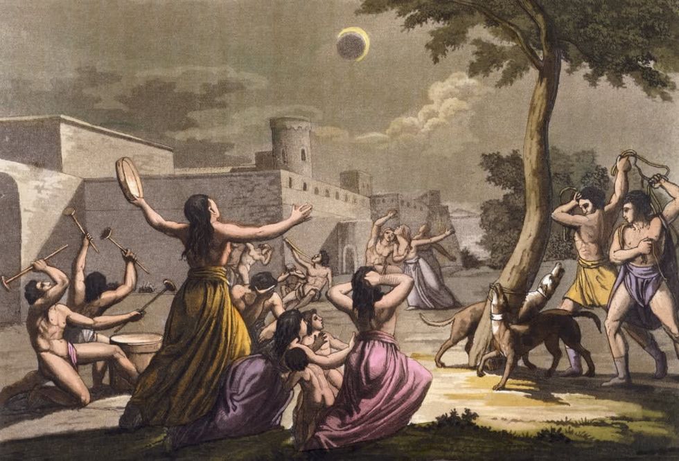 A print of native American Indians celebrating the eclipse of the moon by G. Gallina. (Photo by © Historical Picture Archive/CORBIS/Corbis via Getty Images)