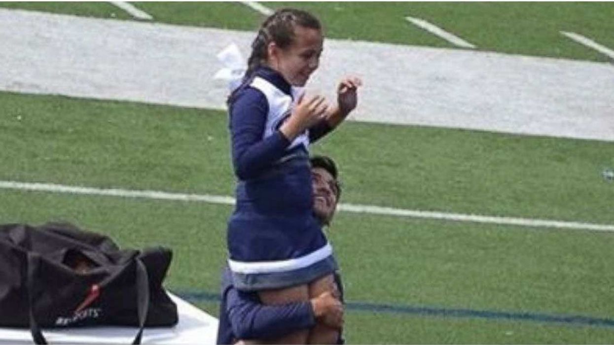 A 9-year-old cheerleader’s veteran dad wasn’t able to help with her routine, so a school senior stepped up