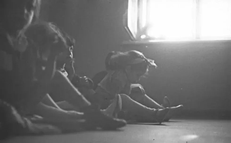 Children sitting on the floor.