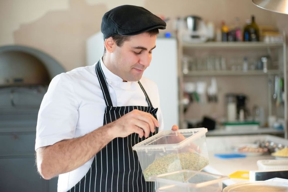 containers, plastic containers, man in apron, man with hat, cleanliness