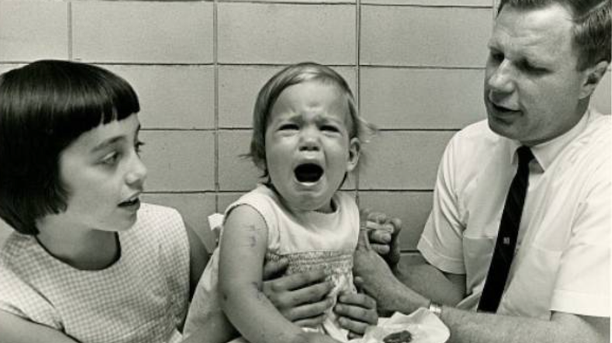 Dr. Hilleman giving a vaccine to his daughter