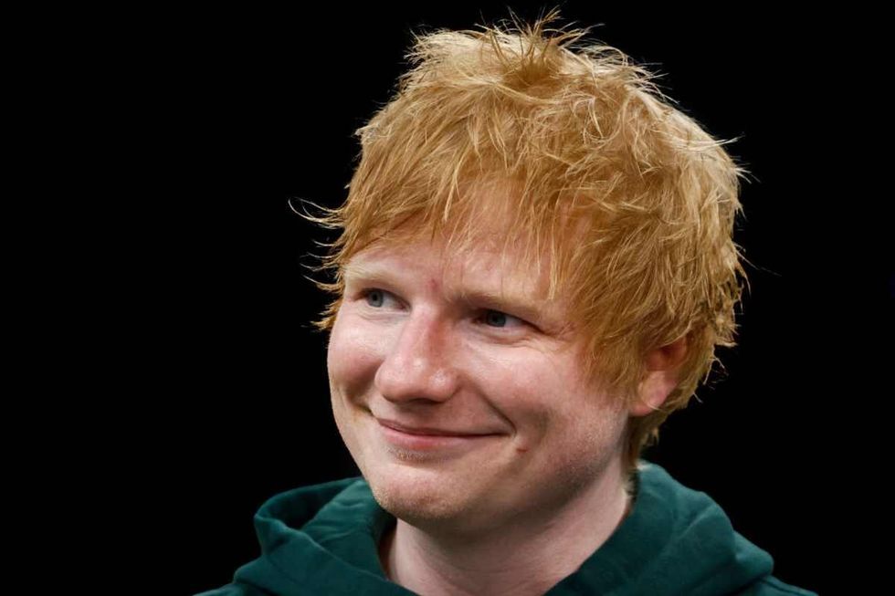 English singer and songwriter Ed Sheeran smiles on the court before Game 2 of the Eastern Conference Final in Boston, Massachusetts. (Image Source: Getty Images | Photo By Winslow Townson)