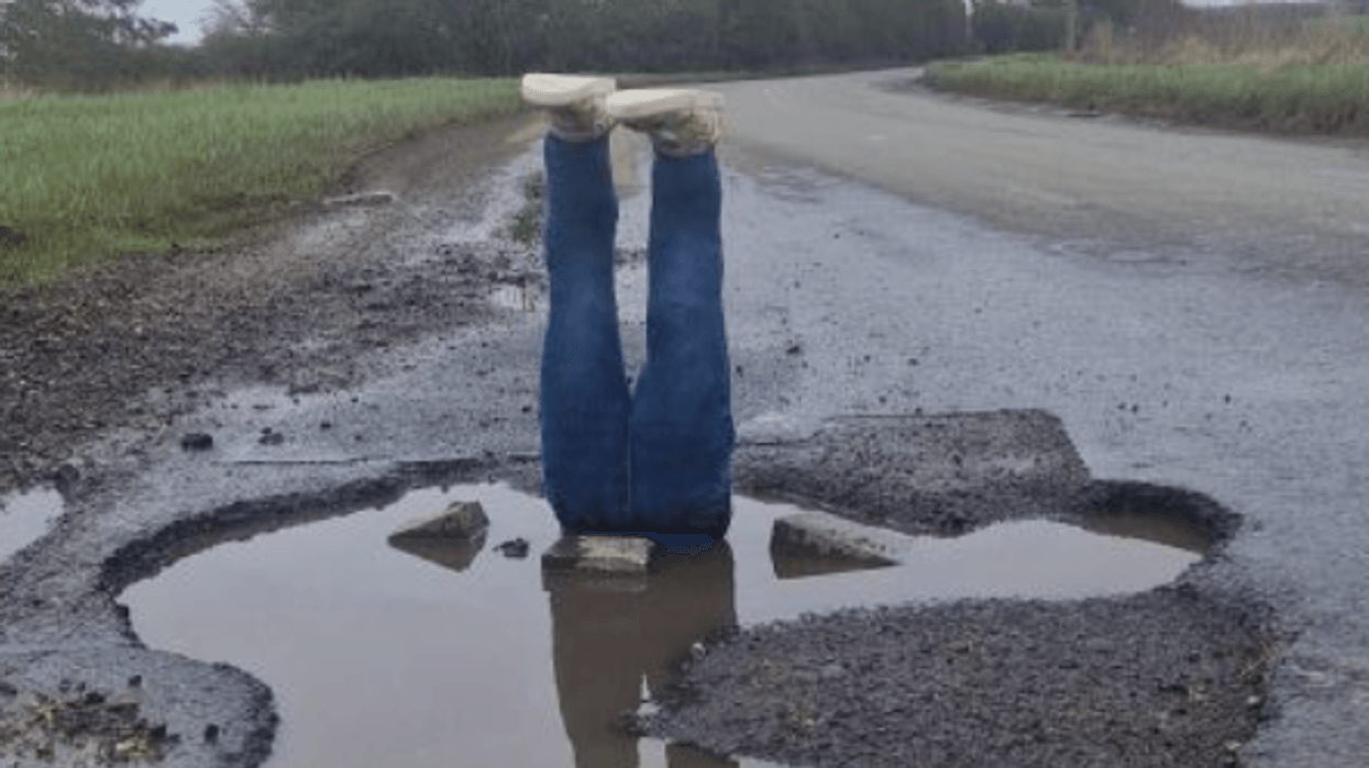 feet sticking out of pothole