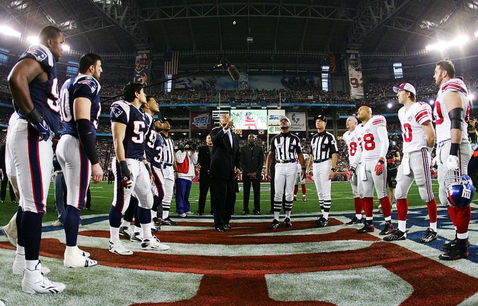 GLENDALE, AZ - FEBRUARY 03: Hall of Famer Ronnie Lott performs the coin toss before the New York Giants take on the New England Patriots during Super Bowl XLII on February 3, 2008 at the University of Phoenix Stadium in Glendale, Arizona. (Photo by Harry How/Getty Images)