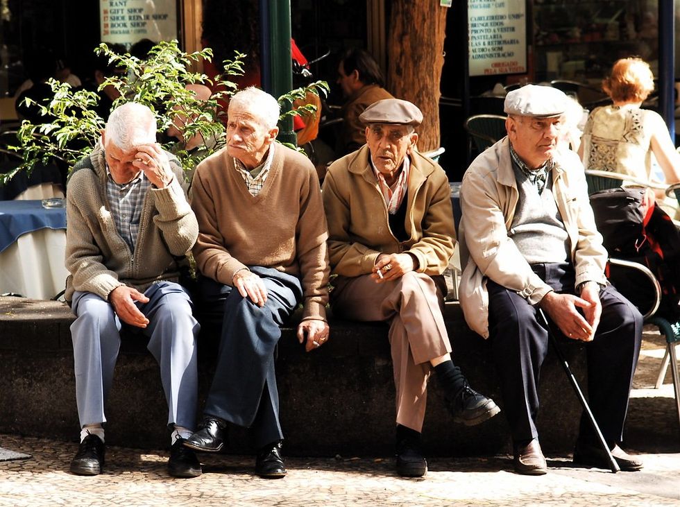 group of elderly men sitting in the sun