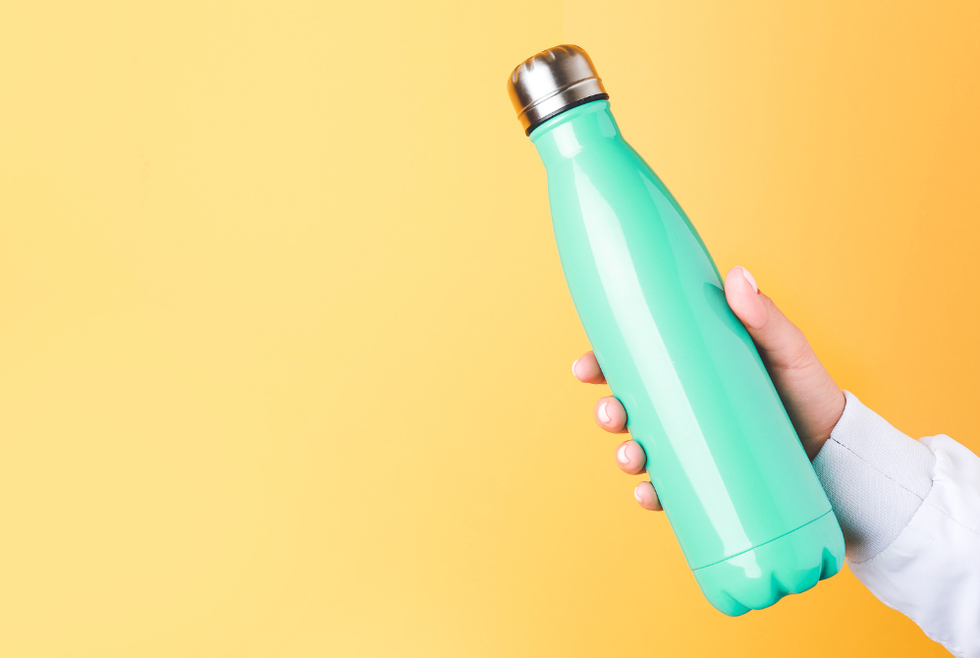 Hand holding metal water bottle