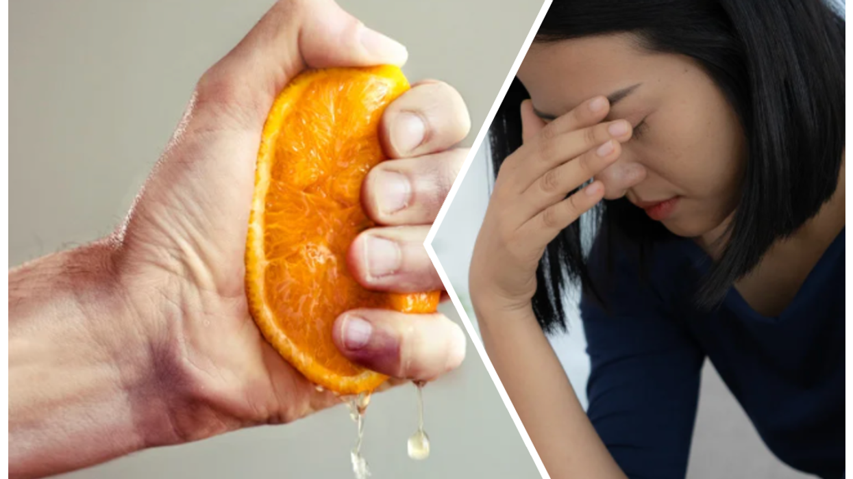 Hand squeezing orange/depressed woman