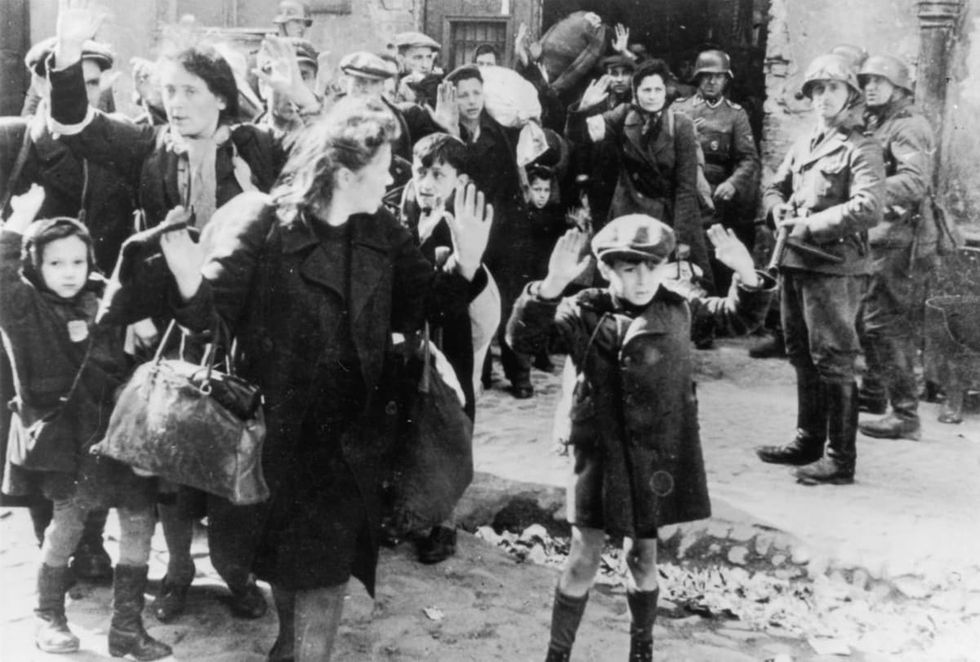 Image Source: A group of Jewish civilians being held at gunpoint by German SS troops after being forced out of a bunker where they were sheltering in German-occupied Poland. Photo by © Hulton-Deutsch Collection/CORBIS/Corbis via Getty Images)