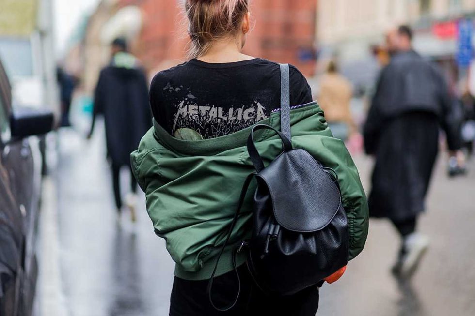 Image Source: A guest wearing a black Metallica t-shirt, olive bomber jacket, and black backpack outside Stylein during the Stockholm Fashion Week Spring/Summer 2017 on August 29, 2016. (Photo by Christian Vierig/Getty Images)