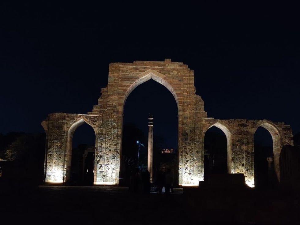 Image Source: A views of the Iron Pillar of Delhi in the Qutab Minar complex at night on February 20, 2022 in New Delhi, India. (Photo by Pallava Bagla/Corbis via Getty Images)