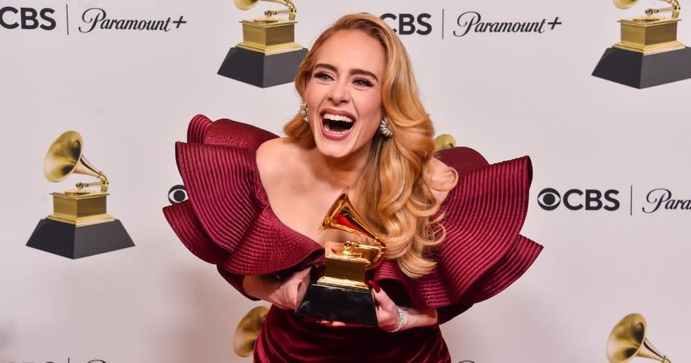 Image Source : Adele poses with the Best Pop Solo Performance Award for