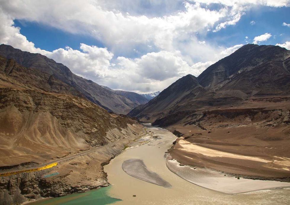 Image Source: Aerial view of the confluence of the Indus and Zanskar rivers, Ladakh, Leh, India on June 16, 2023 in Leh, India. (Photo by Eric Lafforgue/Art in All of Us/Corbis via Getty Images)