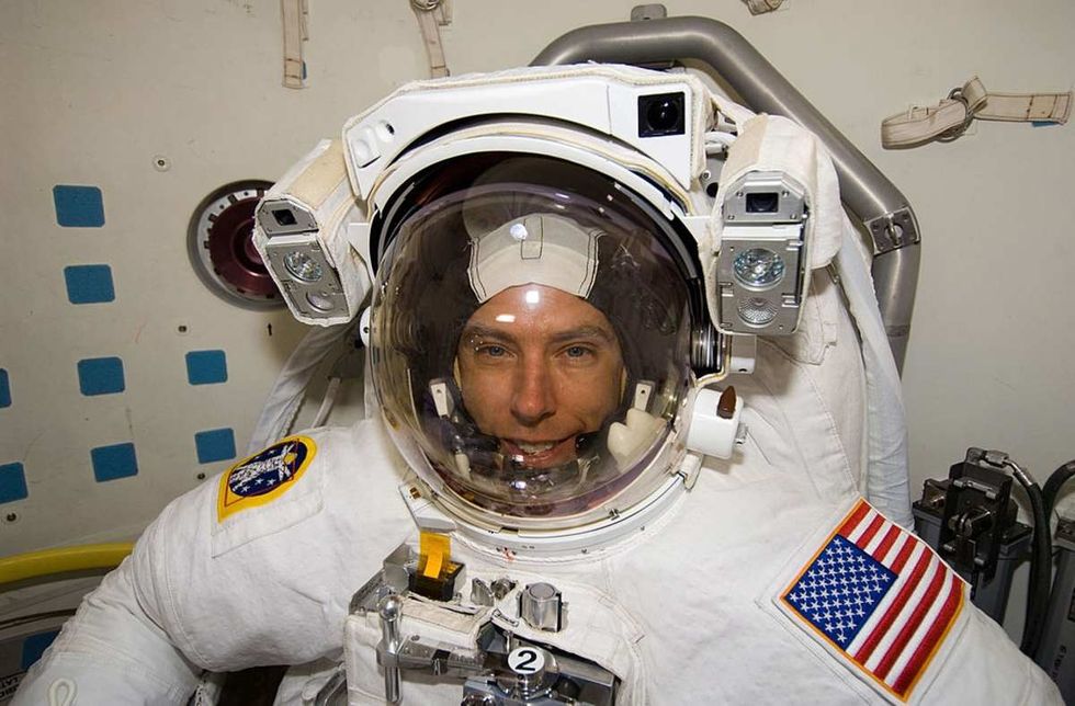 Image Source: Astronaut Andrew Feustel, STS-125 mission specialist, attired in his Extravehicular Mobility Unit (EMU) spacesuit, in the Space Shuttle Atlantis' airlock. (Photo NASA via Getty Images)