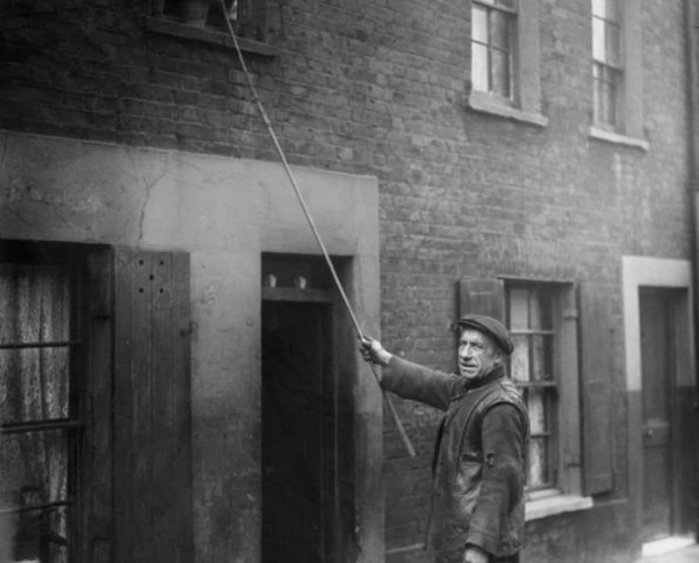 Image source: Charles Nelson of Hoxton in East London has been working as a 'knocker-up' for 25 years. He wakes up early morning workers such as doctors, market traders and drivers. (Photo by J. Gaiger/Topical Press Agency/Getty Images)