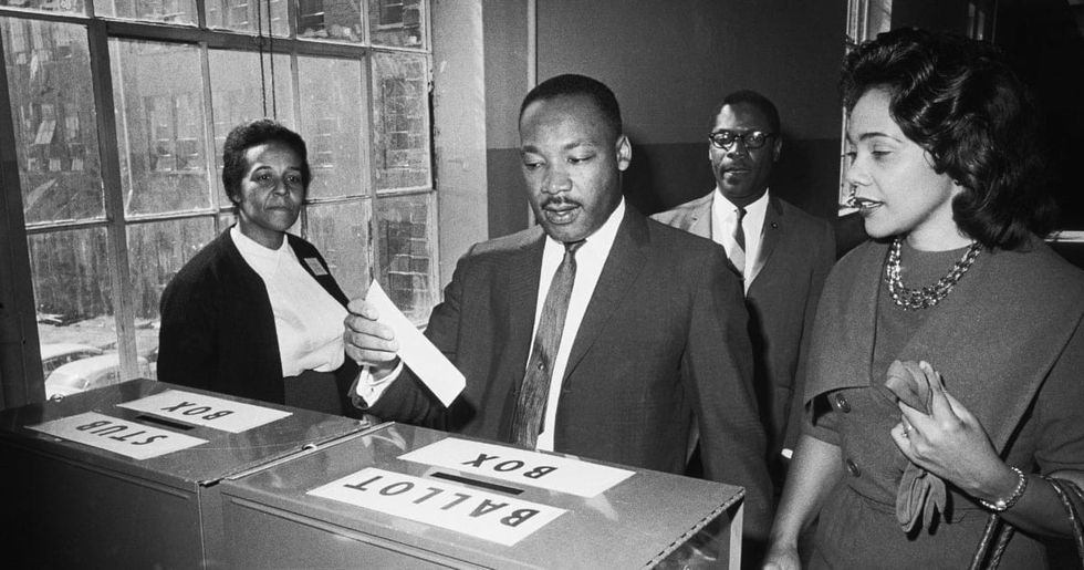 Image Source : Dr Martin Luther King Jr votes as his wife, Coretta Scott King, waits her turn.(Photo by Bettmann/Getty Images)