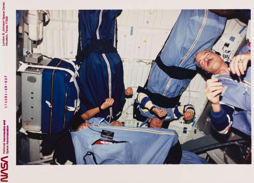 Image Source: Four of the five STS-51 astronaut crew members during one of their sleep periods on Discovery's middeck. Bottom center Frank L Culbertson Jr, mission commander, and (L-R) Daniel W Bursch and Carl E Walz, mission specialists, and William F Readdy, pilot. The picture was taken by James H Newman, mission specialist. (Photo by Space Frontiers/Getty Images)