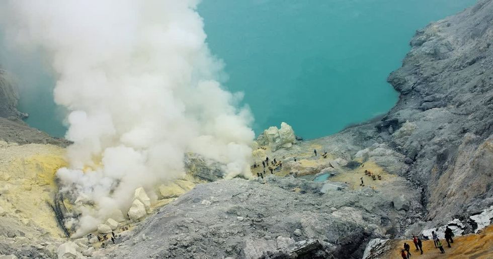 Image Source:  Ijen Volcano is 2,600 meters tall (8,660 ft), topped with a large caldera and a 200 meter deep lake of sulfuric acid. (Photo by Robertus Pudyanto/Getty Images)