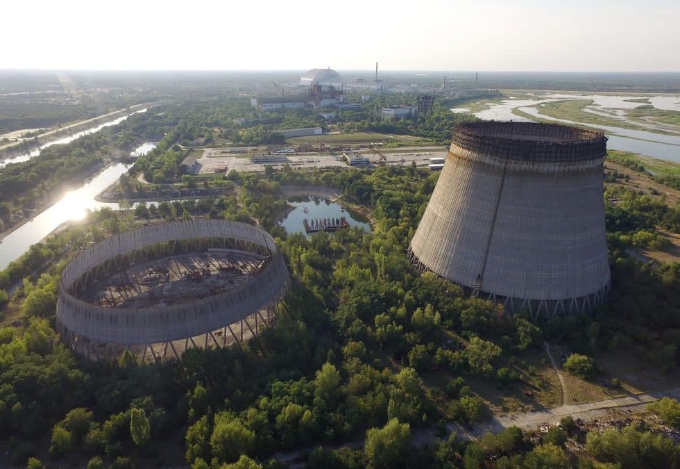 Image Source: In this aerial view abandoned, partially-completed cooling towers stand at the Chernobyl nuclear power plant. (Photo by Sean Gallup/Getty Images)