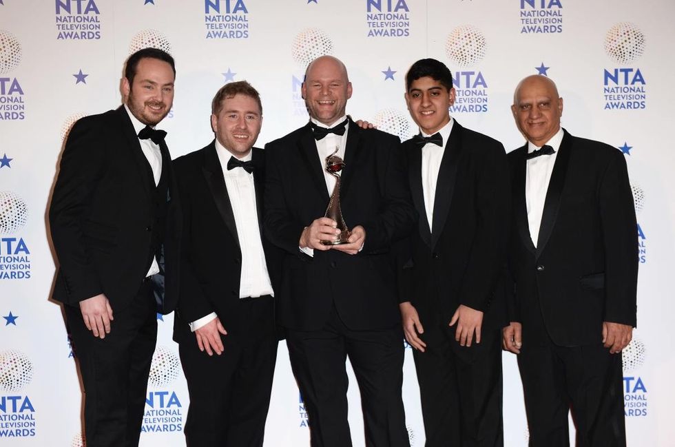 Image Source: Jonny Mitchell (C), Matthew Burton (L), Michael Steer (2ndL) and Musharaf Asghar (2ndR) pose with their Best Documentary Series award for 'Educating Yorkshire' during National Television Awards 2014 in England. (Photo by Ian Gavan/Getty Images)
