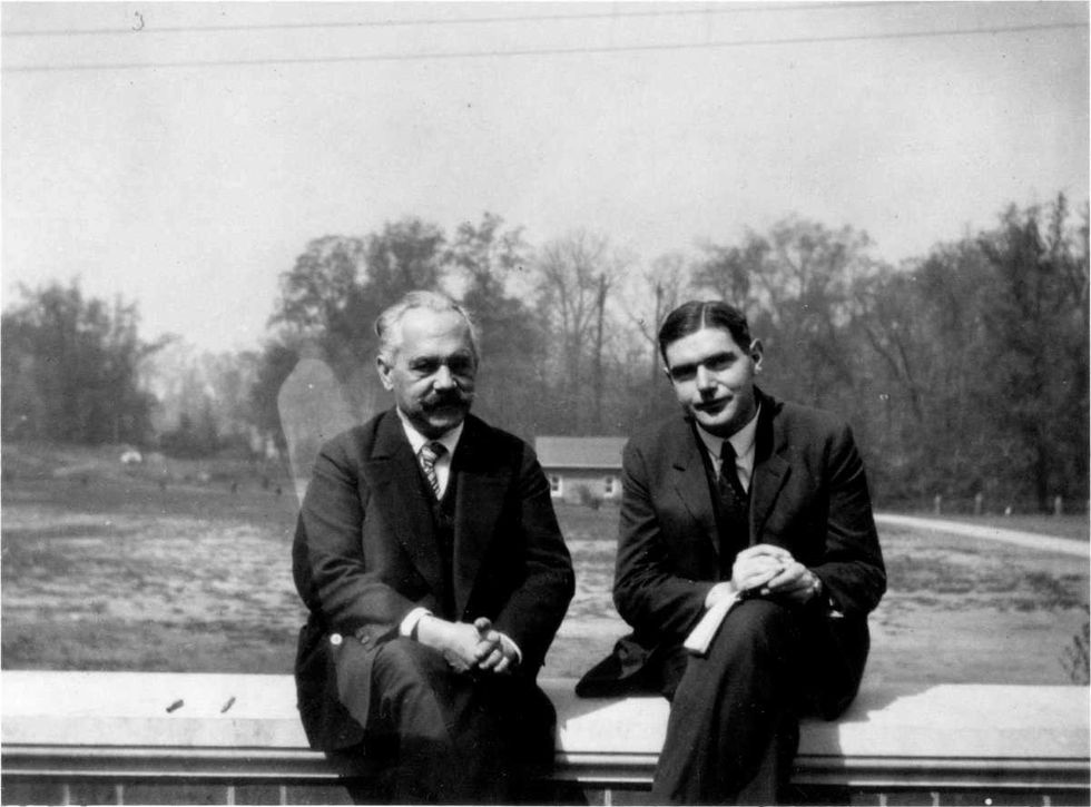 Image Source: (L) Professor Arnold Sommerfeld, professor at the University of Munich, and (R) Karl Ferdinand Herzfeld, professor at Johns Hopkins University and Austrian-American physicist, sitting on a wall, 1929. (Photo by JHU Sheridan Libraries/Gado/Getty Images)