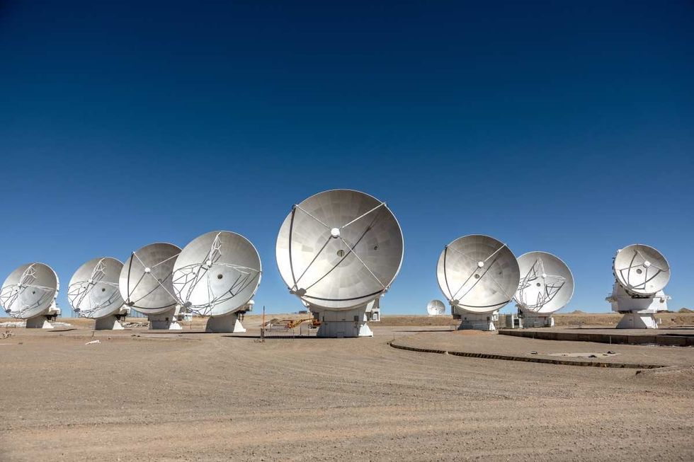 Image Source: Massive antennas, part of the Atacama Large Millimeter/submillimeter Array (ALMA) radio telescope, stand in position on August 26, 2022 on the Chajnantor Plateau of northern Chile. (Photo by John Moore/Getty Images)