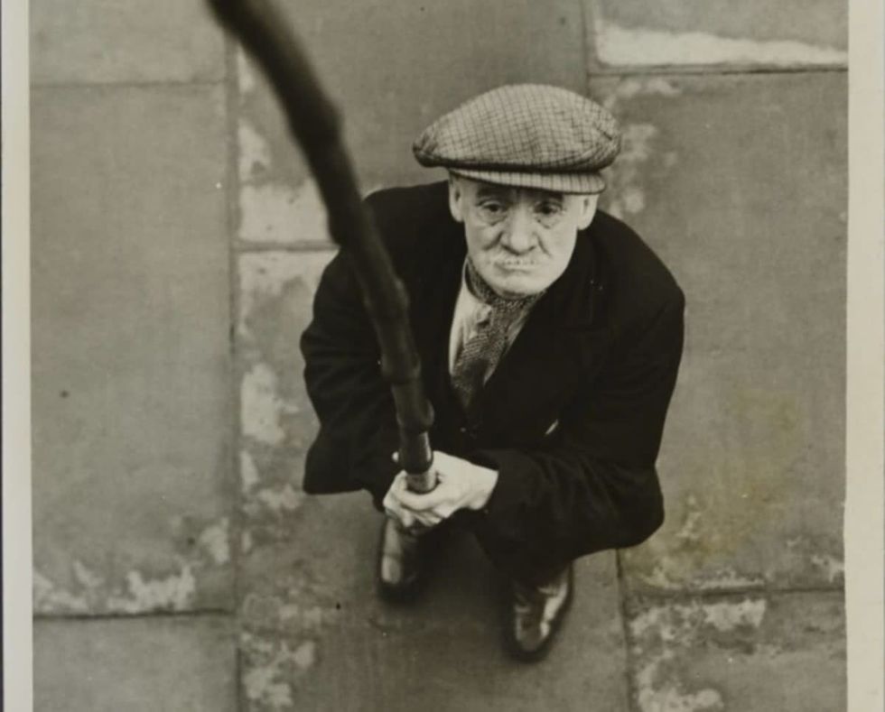 Image source: Mr William Crompton of Bolton is the oldest knocker-ups who wake factory workers every morning. He charges from fourpence to sixpence a week, according to the time he calls his customers. (Photo by Hulton Archive/Getty Images)