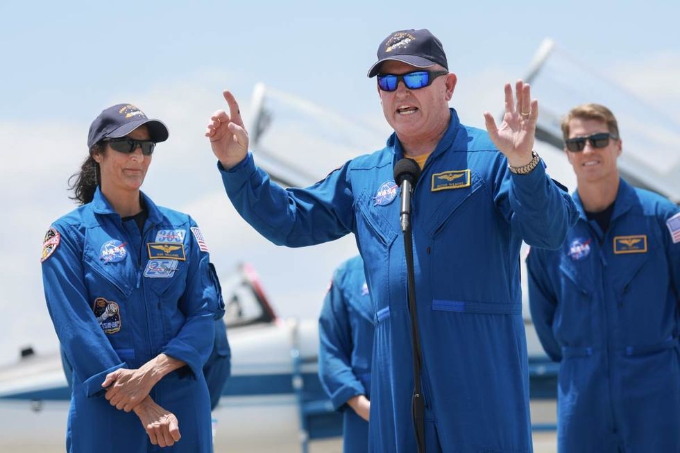 Image Source: NASA’s Boeing Crew Flight Test Commander Butch Wilmore and Pilot Suni Williams address the media after arriving at the Kennedy Space Center on April 25, 2024. (Photo by Joe Raedle/Getty Images)