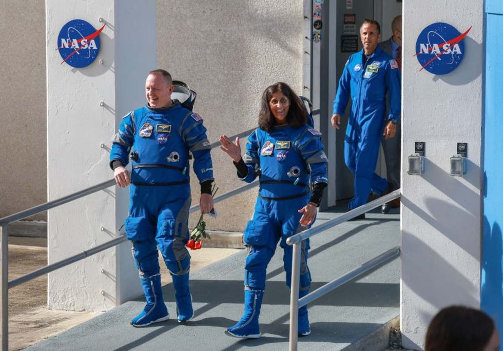 Image Source: NASA’s Boeing Crew Flight Test Commander Butch Wilmore (L) and Pilot Suni Williams walk out of the Operations and Checkout Building on June 01, 2024 in Cape Canaveral, Florida. (Photo by Joe Raedle/Getty Images)