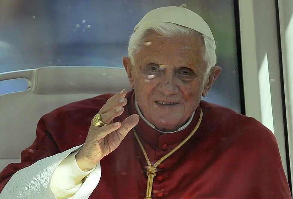 Image Source: Pope Benedict XVI waves to the crowd on his way from the La Sagrada Familia on November 7, 2010, in Barcelona, Spain. (Photo by David Ramos/Getty Images)