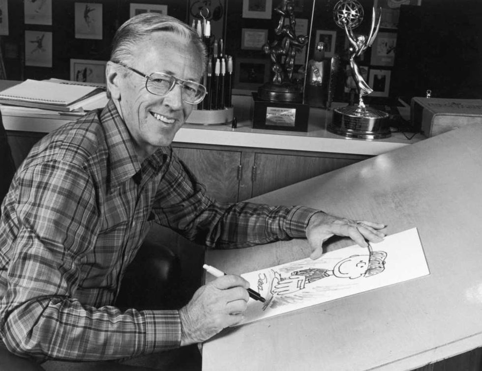 Image Source:  Portrait of American cartoonist Charles M Schulz (1922 - 2001), creator of the 'Peanuts' comic strip, sitting at his studio with a picture of his character Charlie Brown (Photo by CBS Photo Archive/Getty Images)
