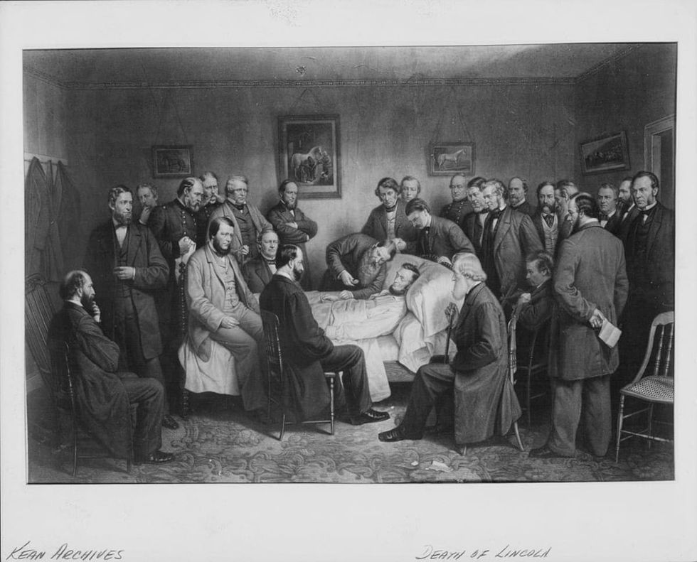 Image source: Printed lithograph of the death bed of President Abraham Lincoln, surrounded by his family and colleagues following his assassination, April 15th 1865. (Photo by Archive Photos/Getty Images)