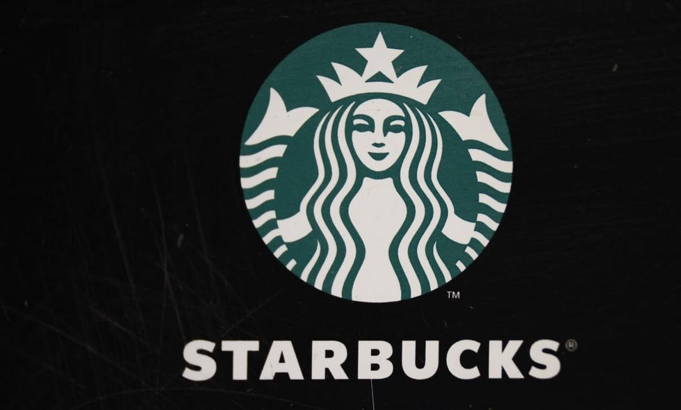 Image Source: Starbucks Cafe logo at Rua dos Clerigos on March 23, 2024, in Porto, Portugal. (Photo by Horacio Villalobos#Corbis/Corbis via Getty Images)