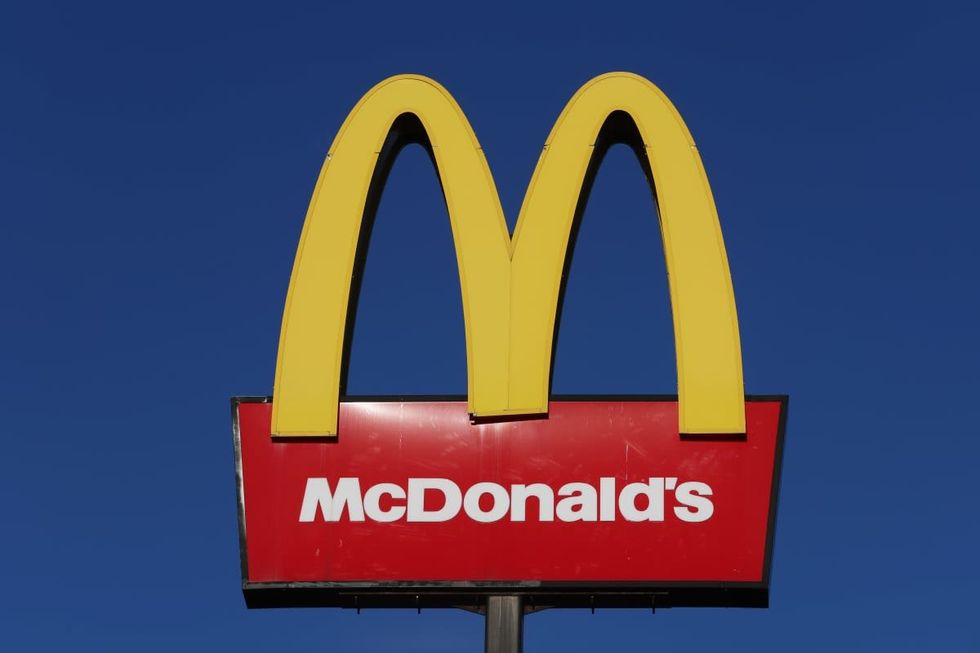 Image Source: The American fast food company, McDonalds logo is displayed outside one of its stores on January 09, 2024 in Stoke-on-Trent, United Kingdom. (Photo by Nathan Stirk/Getty Images)