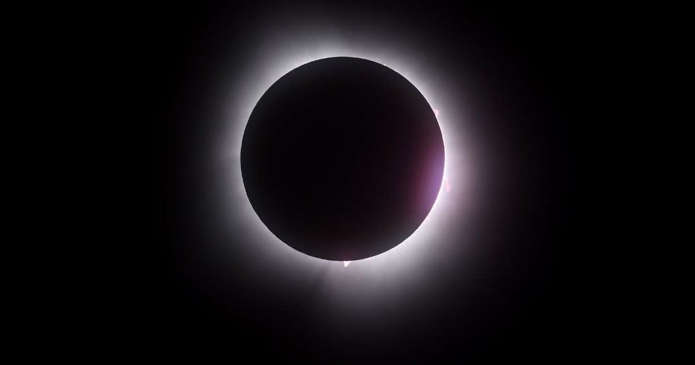 Image Source : The moon passes in front of the sun during a solar eclipse on April 08, 2024 in Martin Ohio. Millions of people have flocked to areas across North America that are in the