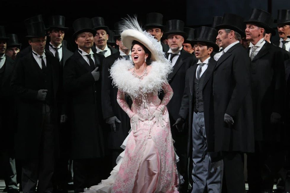 Image Source: The soprano Lisette Oropesa (Manon Lescaut), center, and the baritone Brett Polegato (De Bretigny), third from right, (he has grey hairs and mustache) in Jules Massenet's