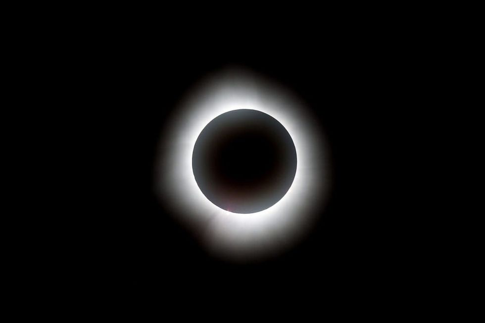Image Source: The total solar eclipse is seen before the game between the Cleveland Guardians and the Chicago White Sox at Progressive Field on April 08, 2024 in Cleveland, Ohio. (Photo by Mike Lawrie/Getty Images)