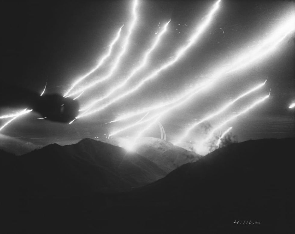 Image Source: Tracers and flares leave streaks in the night sky. (Photo by © CORBIS/Corbis via Getty Images)