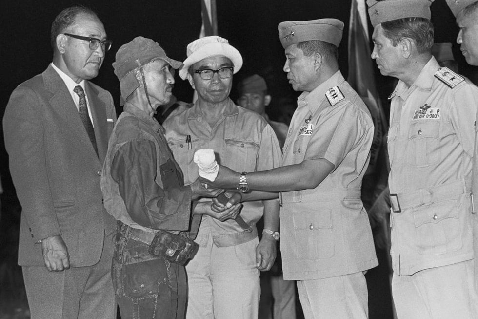 Image Source: World War II Japanese straggler Lt. Hiroo Onada surrenders his sword hereon March 10, 1974, to Major General Jose L. Rancudo the Philippine Air Force Chief at Government radar site on Lubang Island.