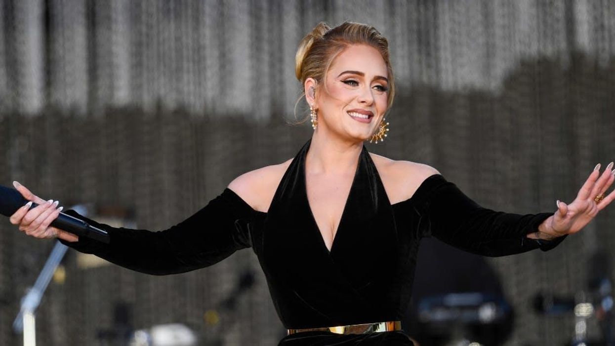 Adele gets emotional after being surprised by her childhood teacher during concert