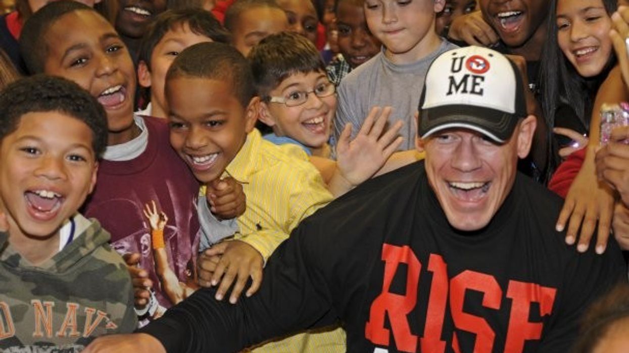 John Cena poses for a picture with a group of children