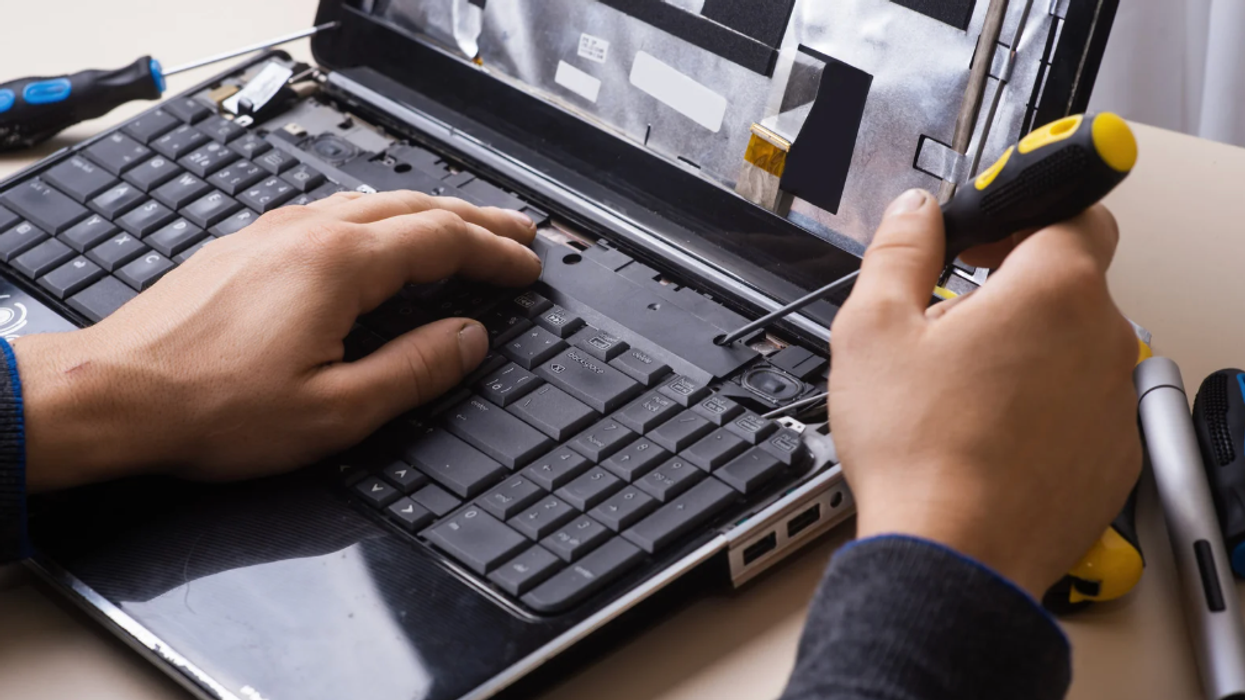 Man fixing laptop
