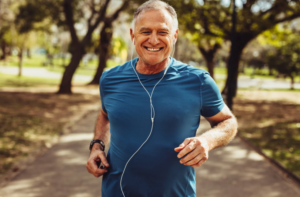 Man jogging outside, smiling