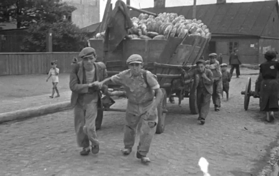 Men hauling the cart for bread distribution.