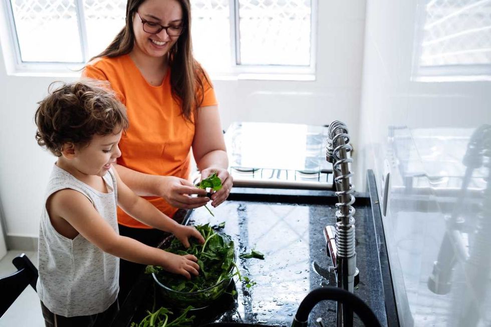 Mother and son washing vegetables (Representative Image Source: Getty Images | Ana Cariane)