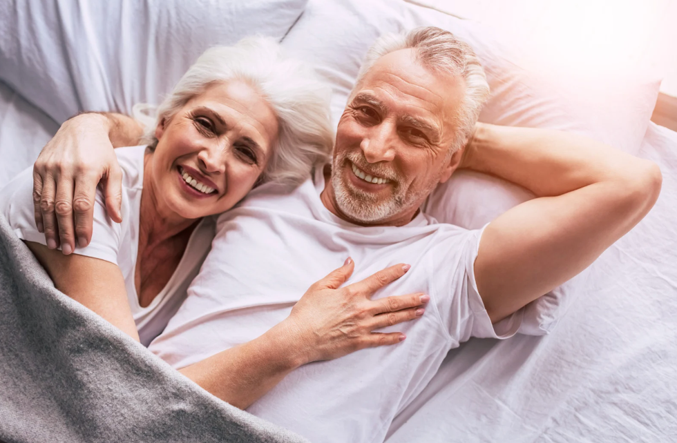 Old couple smiling in bed