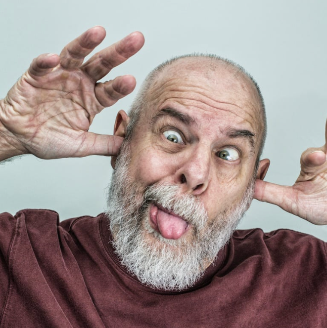 Old man sticking tongue, making goofy face