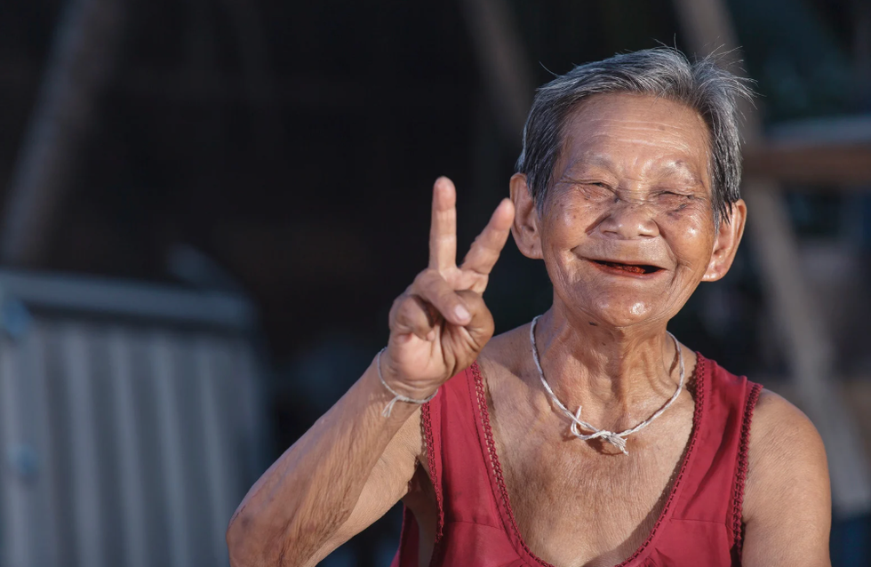 old woman with peace sign