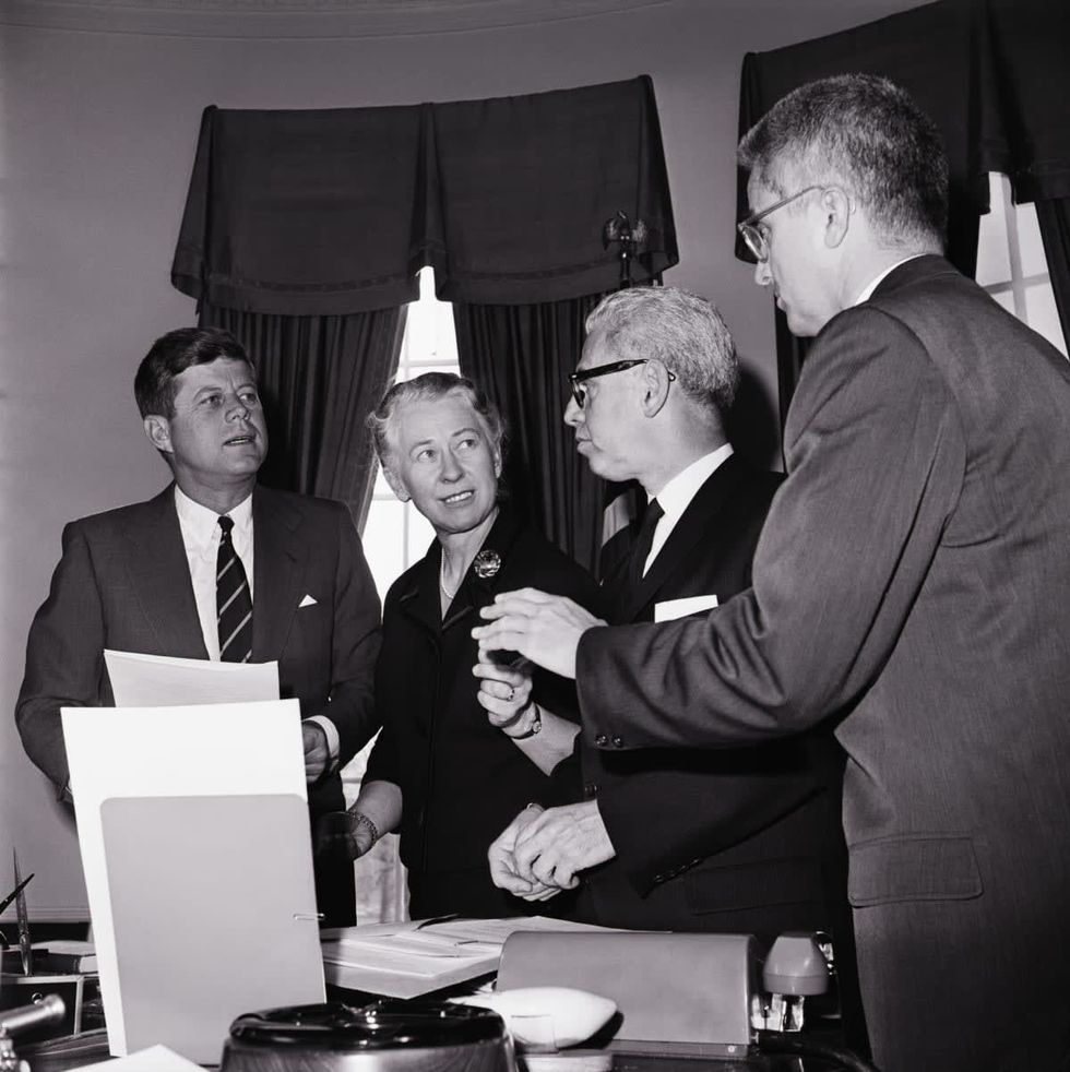 (Original Caption) 12/14/1961-Washington, D.C.: President Kennedy today set up a 26 member commision, headed by Mrs. Eleanor Roosevelt, to reccommend ways of insuring equal rights for women. Shown in the President's office after the commission was announced are, l-r: Pres. Kennedy; Assistant Secretary of Labor Esther Peterson, Executive Vice-Chairman of the Commission; Labor Secretary Arthur Goldberg, a member of the Commission, and John Macy, a member of the Civil Service Commission.