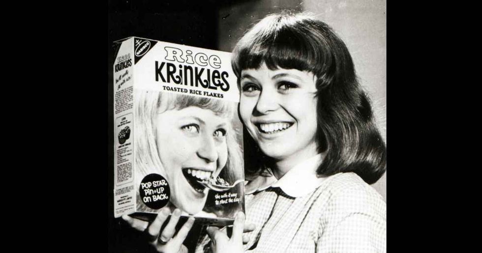 Representative Cover Image Source: Photo of Australian actor Jacki Weaver posing with a box of cereal circa 1965 (Photo by GAB Archive/Redferns)