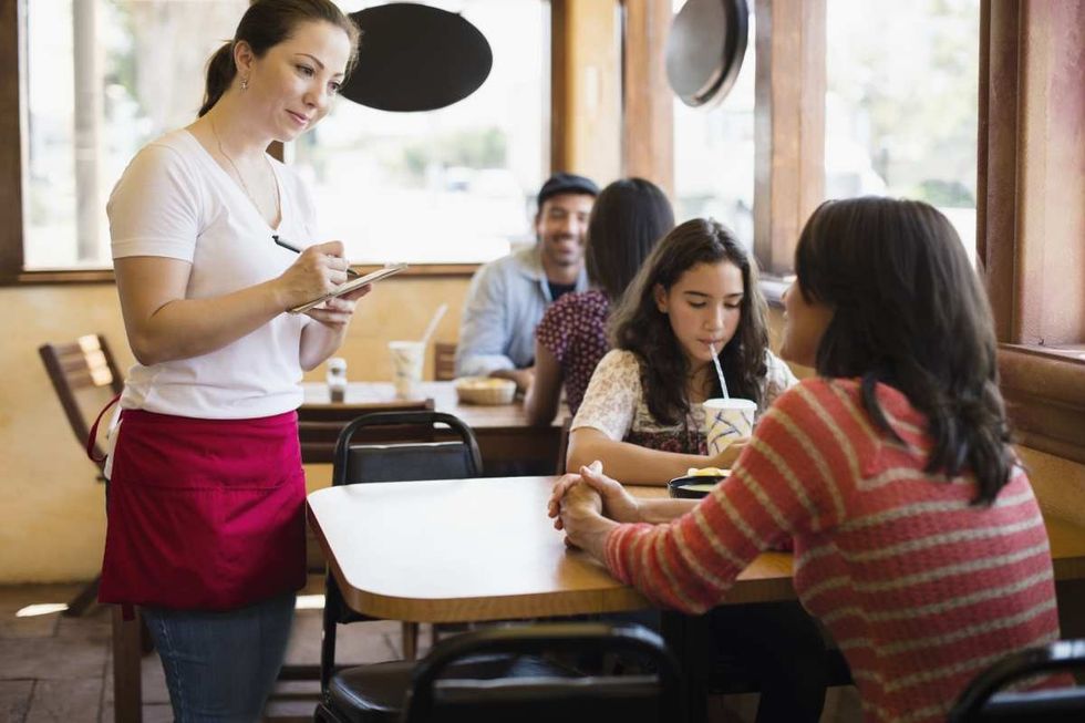 Representative Image Source: A Mexican waitress takes an order in a Taco stand. (Getty Images)